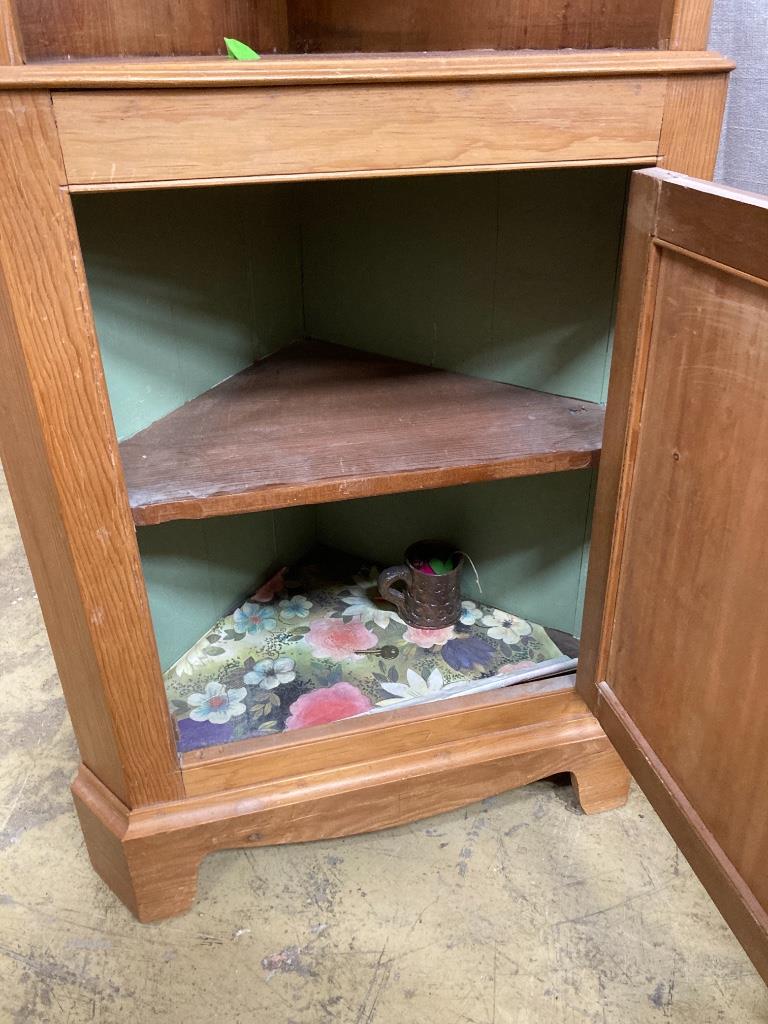 A pine standing corner cabinet, height 180cm